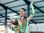 Woman, gymnastics and winner, medal and flowers, wave and happy with celebration and winning competition. Prize, reward and bonus, female champion on podium with gymnast and athlete smile with gift