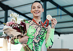 Happy woman, gymnastics and winner, medal and flowers with celebration and winning sports competition. Prize, reward and bonus, female champion on podium with gymnast and athlete smile with gift
