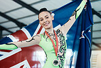 Medal, winner and portrait of champion with union jack, success in competition and gold, award and prize from achievement in tournament. Winning, athlete and celebration on podium in stadium or arena
