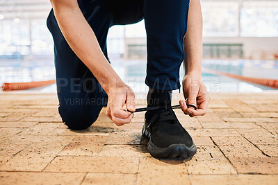 Buy stock photo Man, hands and tying shoes by pool for workout, exercise or training preparation indoors. Closeup of male person or athlete tie shoe and getting ready for sports exercising, fitness or competition
