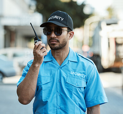 Buy stock photo Walkie talkie, man and a security guard or safety officer outdoor on a city road with communication. Serious male person with radio on urban street to report crime for investigation and surveillance