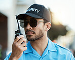 Security guard, safety officer or man with a walkie talkie outdoor on a city road for communication. Serious face of person with a radio on urban street to report crime, investigation or surveillance