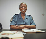 Happy, smile and portrait of a female police officer sitting by a desk in the office writing reports. Confidence, happiness and African woman security guard with a positive mindset in the workplace.
