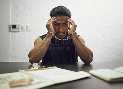 Buy stock photo Man, criminal and handcuffs in fear for interrogation, drugs or crime in arrest on table in room. Worried male person, gangster or suspect in jail, justice or guilty fraud, theft or illegal substance