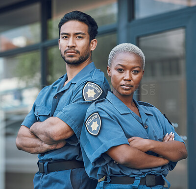 Buy stock photo Portrait, serious and arms crossed with the police force standing outdoor in the city for law enforcement. Safety, security or surveillance with a man and woman officer on patrol in an urban town