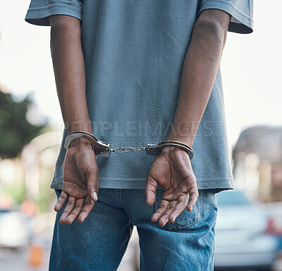 Buy stock photo Hands, handcuffs and man criminal in city arrested for crime, corruption or justice with jail. Security, law and back of male prisoner, thief or gangster, prison or robbery, violence or murder fail 