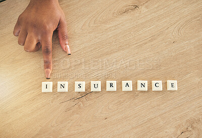 Buy stock photo Insurance, above and hand pointing at blocks or word on a wooden table as a emergency or accident message. Medical, policy and person showing letters of safety or security for future risk management