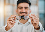 Hands, man and optometrist with glasses for vision, eyesight and prescription eye care. Closeup of doctor, optician and frame of lens for eyewear, test or consulting for optical healthcare assessment