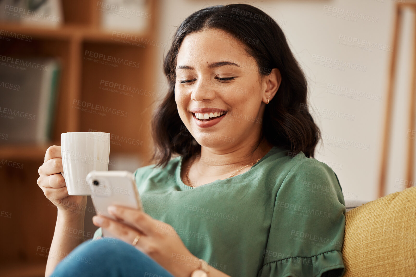 Buy stock photo Happy woman on sofa with phone, coffee and relax, reading email or social media meme in living room. Networking, cellphone and happiness, girl in home with smile, chat and internet search for post.