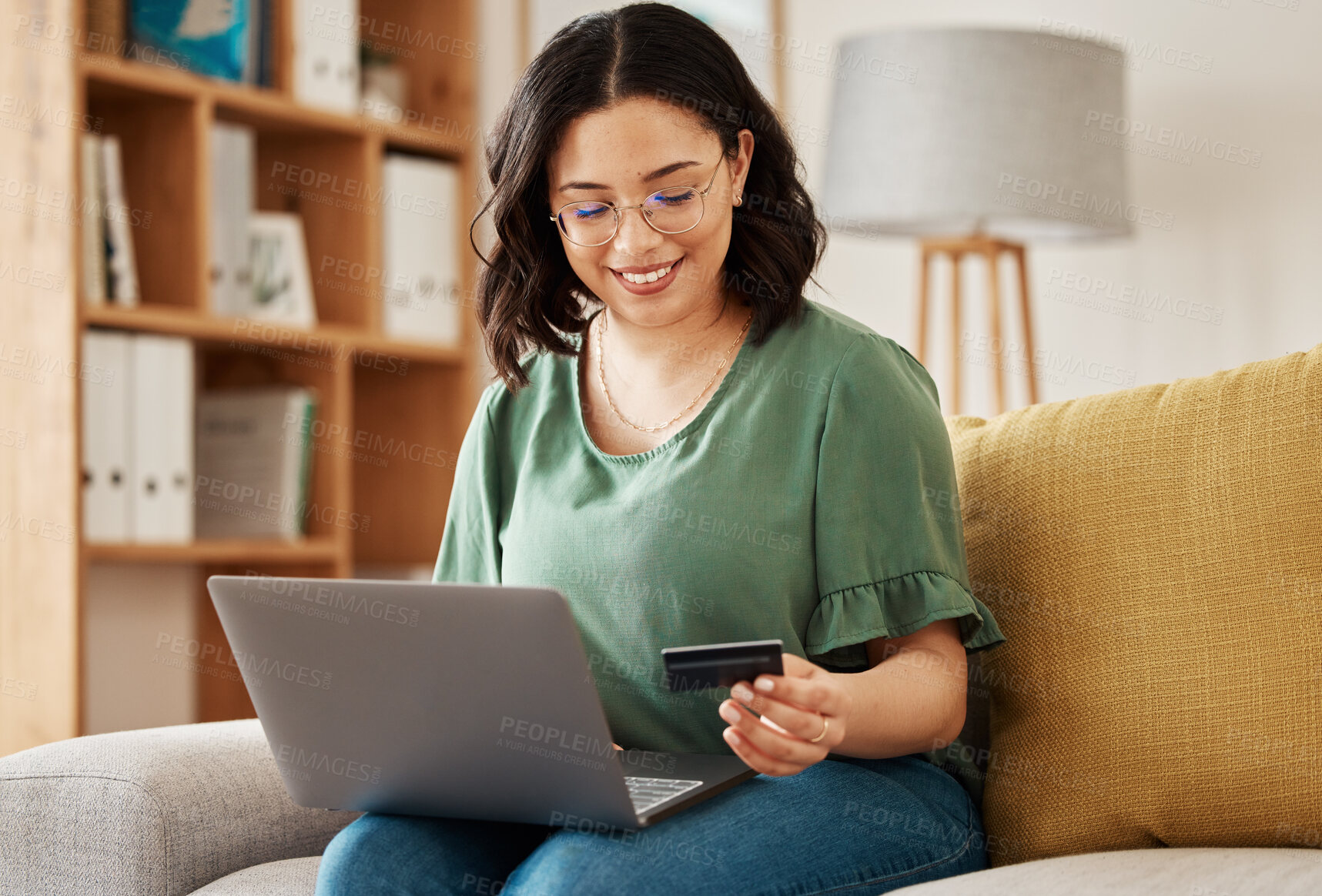 Buy stock photo Online shopping, laptop and credit card, woman on sofa in living room for internet banking app in home with tech. Ecommerce payment, smile and cashback, girl at computer browsing retail website sale.