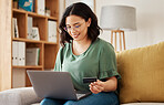 Online shopping, laptop and credit card, happy woman on sofa in living room for internet banking app in home. Ecommerce payment, smile and cashback, girl with computer browsing retail website sale.