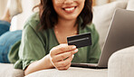 Relax, online shopping and credit card, woman on sofa in living room for internet banking in home with laptop. Happy ecommerce payment, smile and cashback, girl on couch with computer on website sale