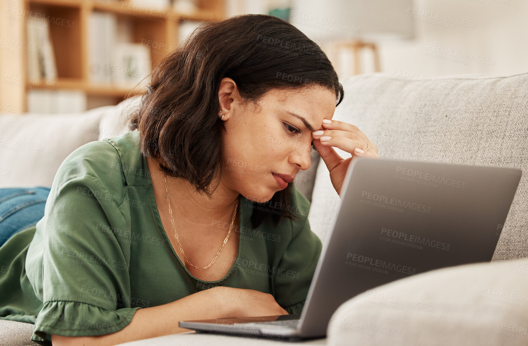 Buy stock photo Woman, home and headache with laptop and remote work stress on a sofa feeling frustrated. House, female person and confused from computer problem with anxiety from online website project on a couch