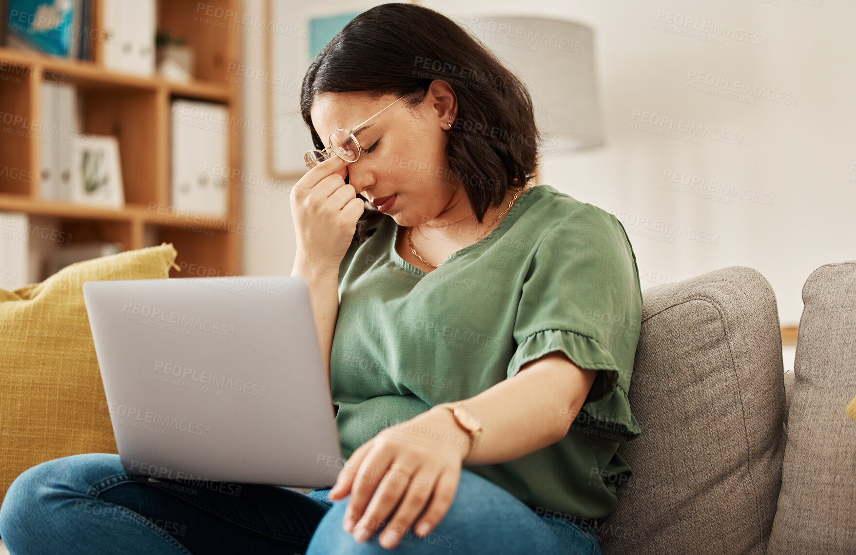 Buy stock photo Woman, home and headache with burnout with laptop and remote work stress on sofa feeling frustrated. House, female person and confused from computer problem with anxiety from online website on couch