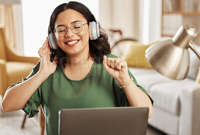 Buy stock photo Laptop, music and headphones with a woman in her home, listening to the radio in the living room to relax. Computer, audio and streaming with a young female student in her house for education