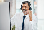 Computer, call center and mature man listening for business, customer service and support. Smile, telemarketing and happy professional, sales agent and crm consultant working at help desk in office