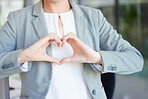 Hands, heart and business woman with love emoji for care, kindness and like review in office. Closeup of female worker with finger shape for thank you, trust and sign of hope, support icon and peace