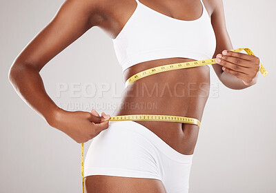 Measuring tape, stomach and woman in studio for wellness, weight loss and  tummy tuck on grey backgr Stock Photo by YuriArcursPeopleimages