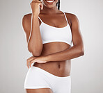 Skin, body and underwear of a woman for health and wellness on a white studio background. Fitness, stomach and skincare of aesthetic female model on a diet for weight loss, balance or motivation