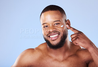 Buy stock photo Beauty, skincare and cream with portrait of black man in studio for sunscreen, cosmetics and spa treatment. Facial, self care and mockup with person on blue background for lotion, wellness and health