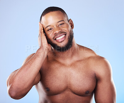 Buy stock photo Happy, skincare and portrait of a black man with a glow on a blue background from dermatology. Smile, touching and an African person or model with facial wellness, health and cleaning for beauty