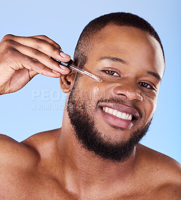 Buy stock photo Black man, portrait and serum for face in studio, aesthetic skincare or dermatology on blue background. Happy male model, facial cosmetics and dropper of hyaluronic acid, collagen and oil for beauty