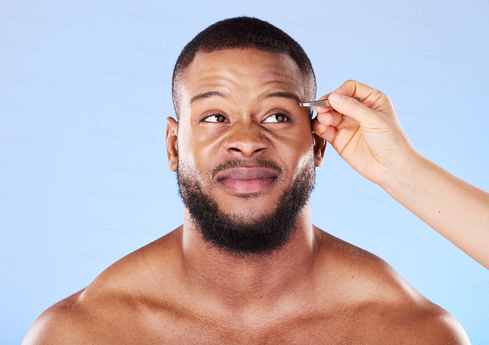 Buy stock photo Beauty, tweezers and young man in a studio for grooming his eyebrows for face epilation. Health, hygiene and male model with facial hair removal treatment for self care isolated by a blue background.