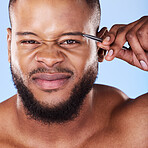 Wellness, tweezers and portrait of a man in a studio for grooming his eyebrows for facial epilation. Beauty, hygiene and young male model with face hair removal treatment isolated by blue background.