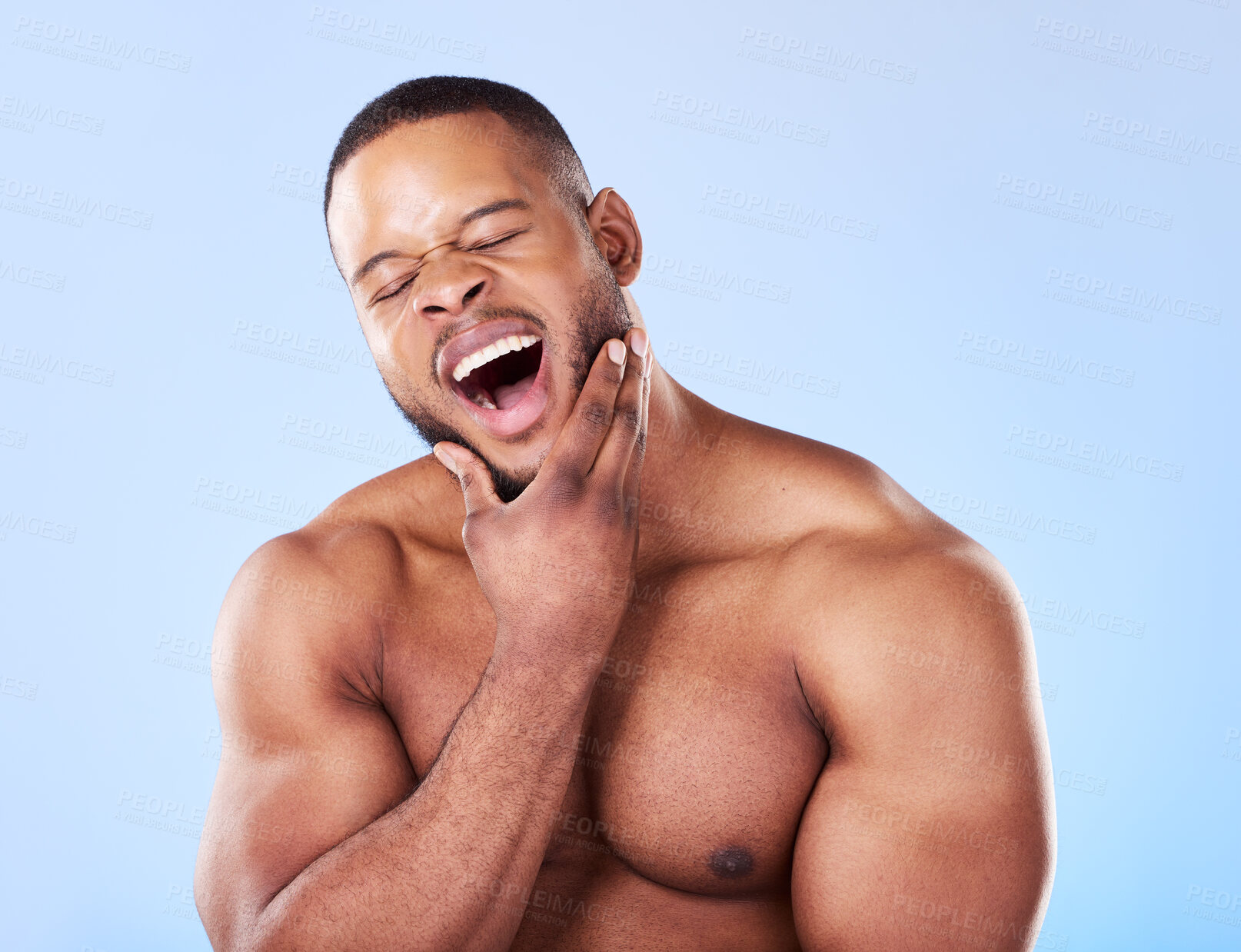 Buy stock photo Tired, yawning and a black man with skincare on a blue background for beauty and wellness. Health, model and an African person or model with fatigue isolated on a studio backdrop for wellbeing