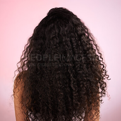 Buy stock photo Woman, back and healthy hair in studio for wellness, cosmetics and growth by pink background. Girl, model and natural coil with balayage, shine and clean glow with texture, results or transformation