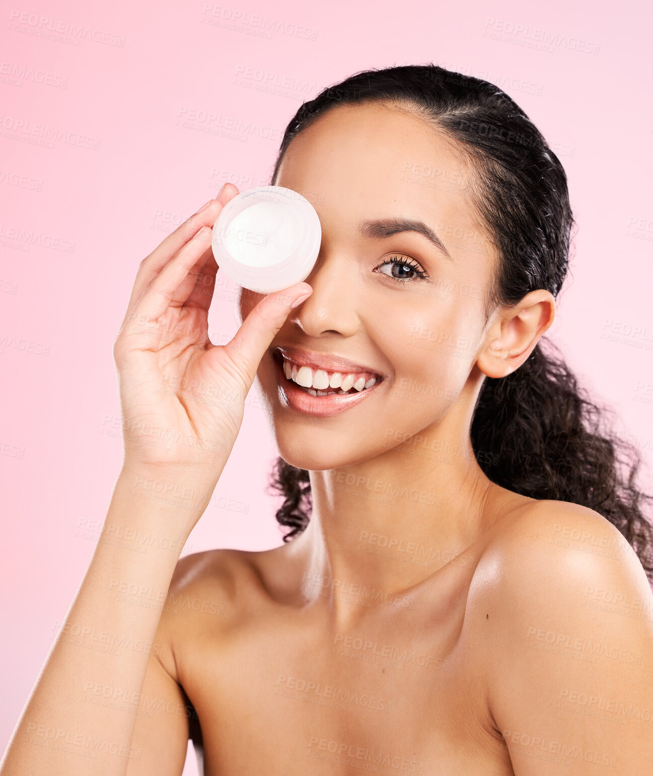 Buy stock photo Face, skincare and woman smile with cream container in studio isolated on a pink background. Portrait, beauty and happy model with moisturizer, sunscreen cosmetic or dermatology product for wellness