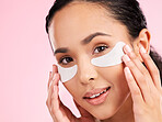 Beauty, face mask and eye patch of a woman with skin care, dermatology and natural glow. Portrait of a young female aesthetic model with cosmetics product for collagen and detox on a pink background