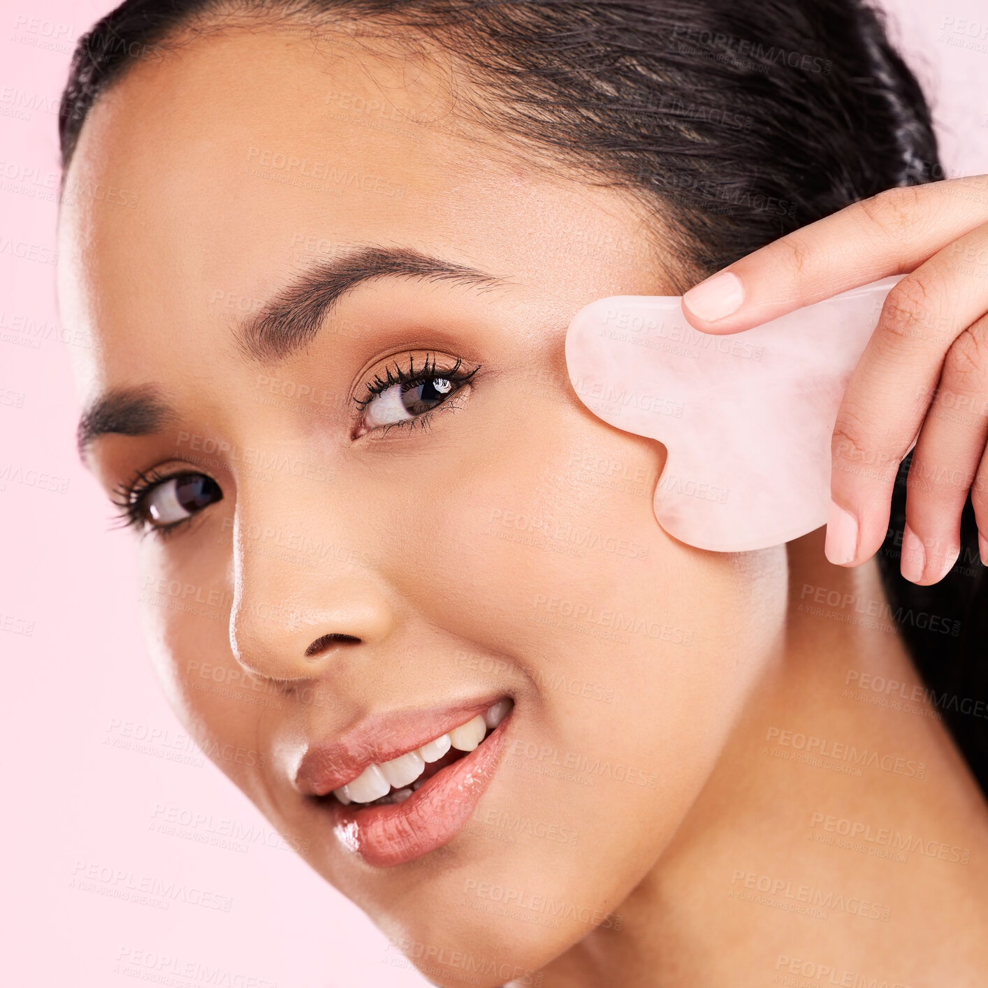 Buy stock photo Natural beauty, face massage and woman with a gua sha, skin glow and cosmetics. Portrait of a young aesthetic female model happy with self care, facial or dermatology results on a pink background