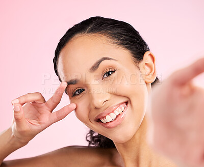 Buy stock photo Selfie, peace hand sign and happy woman in studio with natural beauty, wellness and cosmetics. Portrait, female person and pink background with makeup and face with skincare and emoji gesture of girl