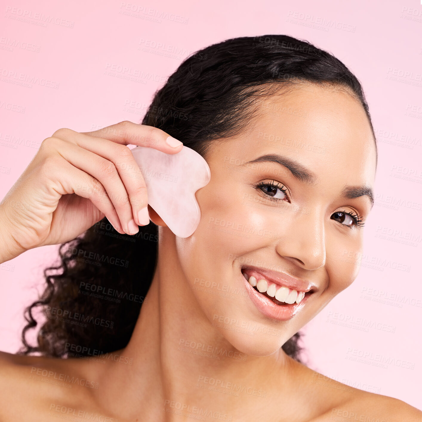 Buy stock photo Gua sha, face massage and woman with natural beauty, skin glow and cosmetics. Portrait of a young aesthetic female model happy with self care, facial or dermatology results on a pink background