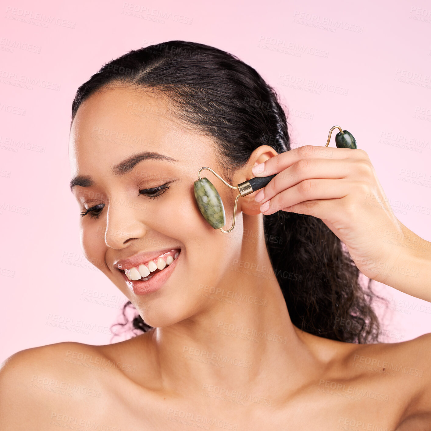 Buy stock photo Natural beauty, facial roller and woman with skin glow, health or wellness cosmetics. Face of a young aesthetic female model happy with dermatology or skincare massage results on a pink background