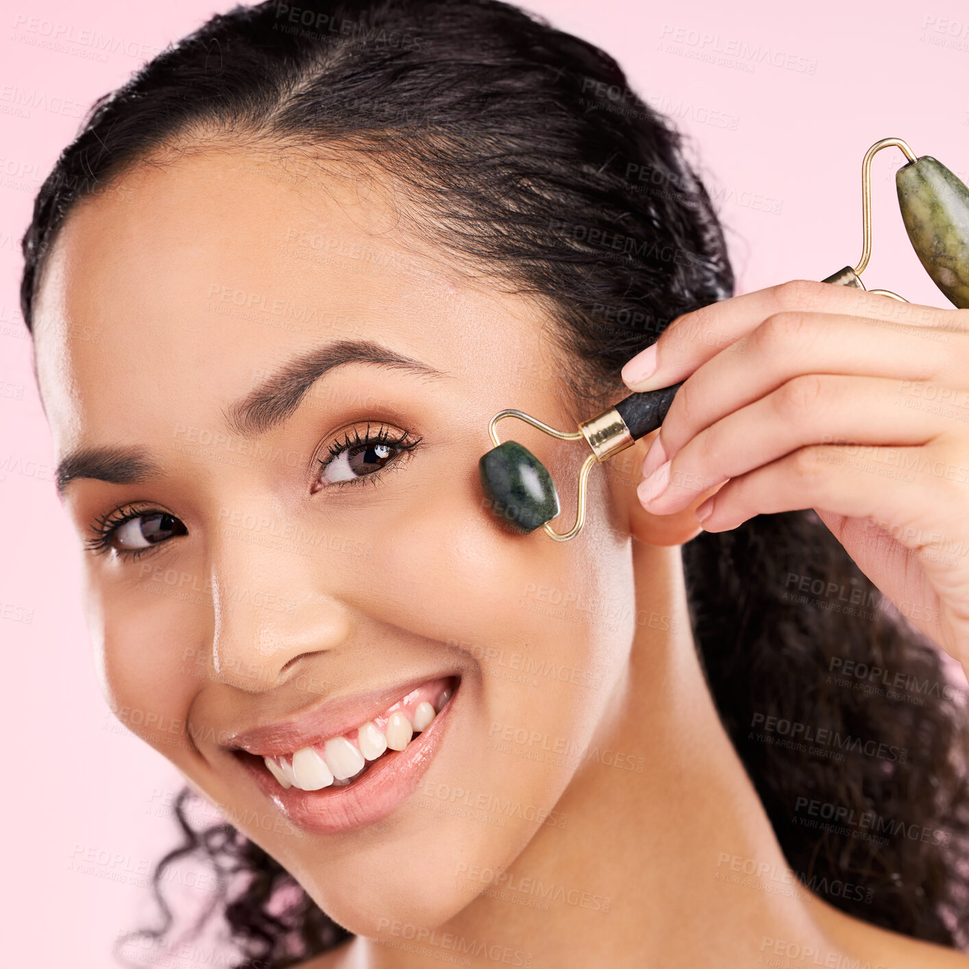 Buy stock photo Facial roller, natural beauty and woman with skin glow, health or wellness cosmetics. Portrait of a young aesthetic female model happy with dermatology or stone massage results on a pink background