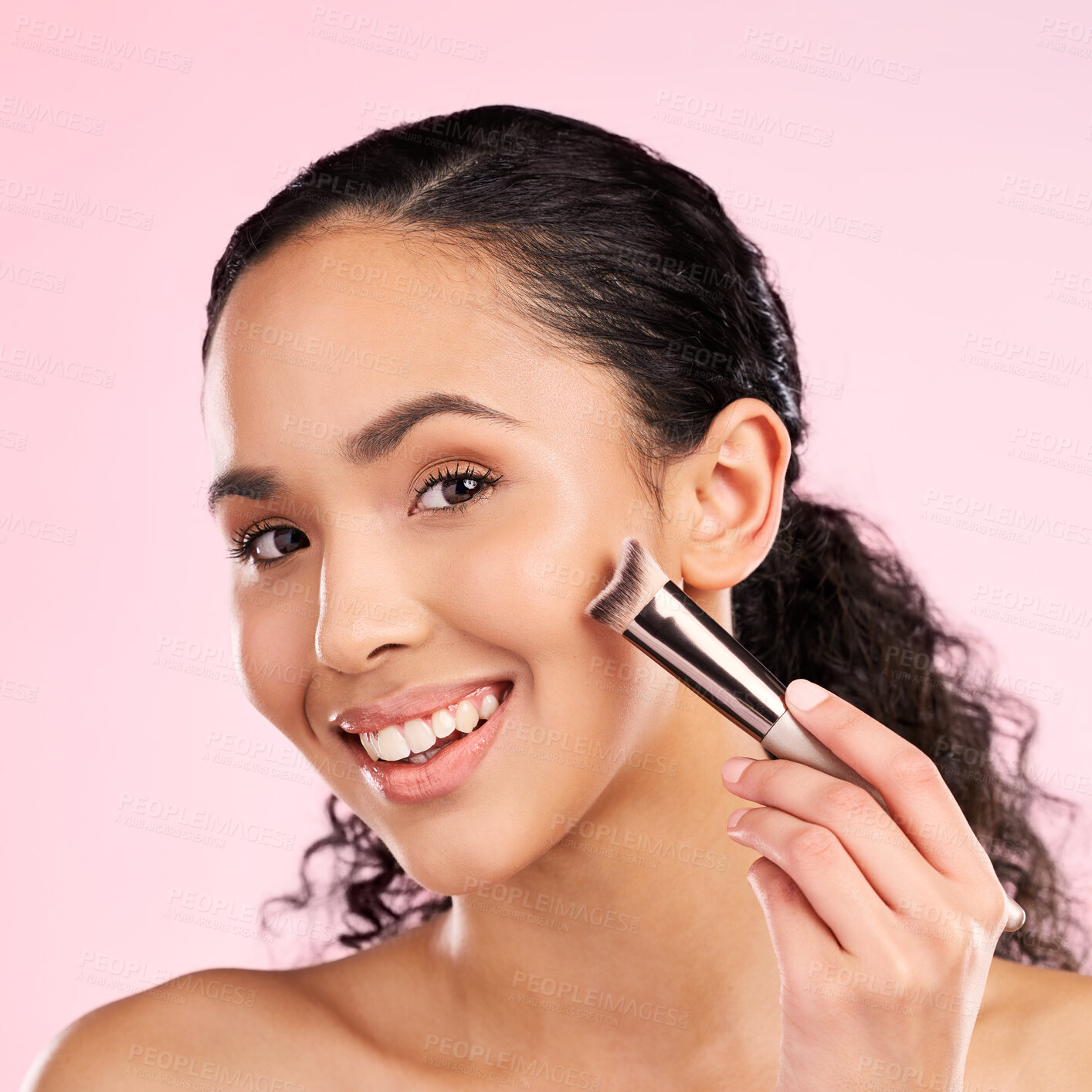 Buy stock photo Smile, makeup and brush with portrait of woman in studio for foundation, cosmetics and facial. Skincare, health and self care with female model on pink background for dermatology, beauty and product