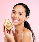 Beauty, avocado and face of a happy woman with skin care, dermatology and natural glow. Portrait of female aesthetic model with fruit for moisturizer, cosmetics or diet nutrition on a pink background