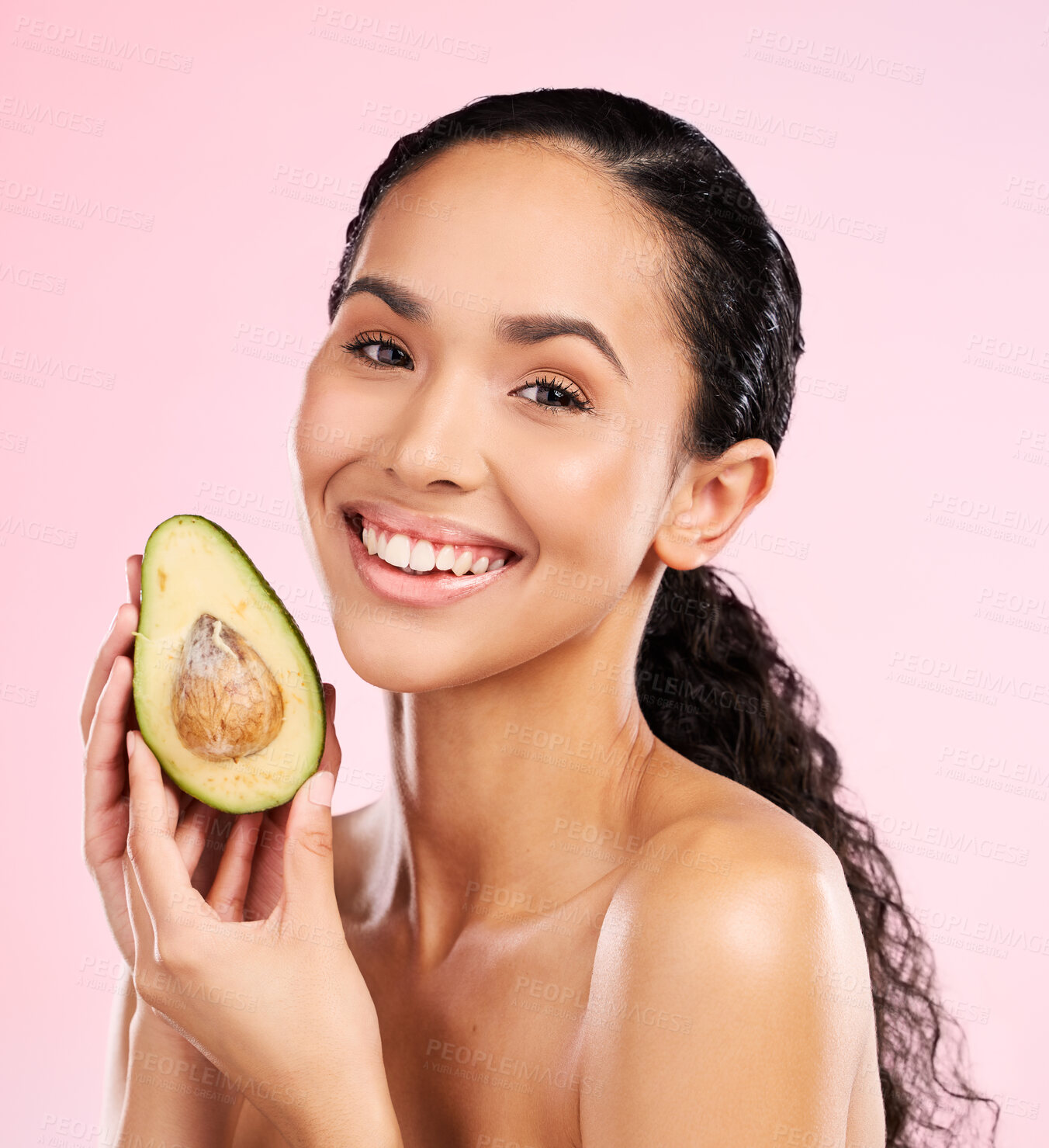 Buy stock photo Beauty, avocado and face of a happy woman with skin care, dermatology and natural glow. Portrait of female aesthetic model with fruit for moisturizer, cosmetics or diet nutrition on a pink background