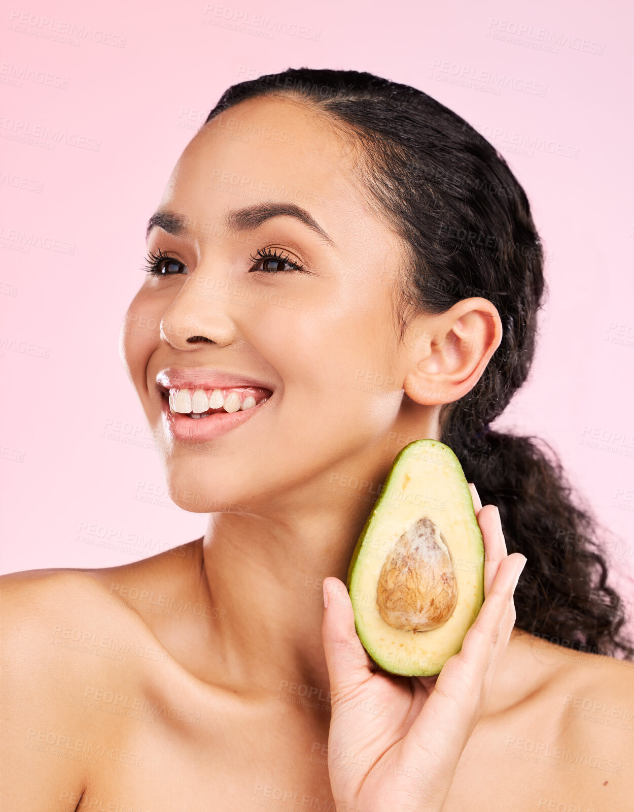 Buy stock photo Avocado, skincare and happy woman thinking of healthy facial, natural cosmetics and beauty ideas. Young african person or model green fruit for vegan product and dermatology on pink studio background