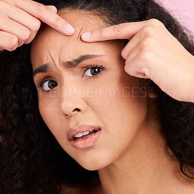 Buy stock photo Skincare, woman and squeeze pimple or problem with natural beauty in pink studio background. Face, check and girl with acne or blackhead for dermatology for cosmetic or wellness with self care.