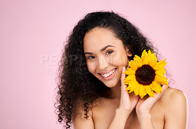 Buy stock photo Face, skincare and beauty of woman with sunflower in studio isolated on a pink background mockup. Portrait, smile and natural model with flower, floral cosmetics or organic treatment for healthy skin