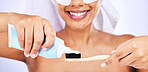 Toothpaste, toothbrush and woman with an oral care routine in a studio for health and wellness. Smile, dental hygiene and closeup of female model getting ready to brush her teeth by white background.