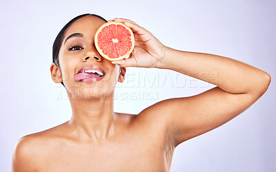 Buy stock photo Woman, portrait and grapefruit for natural beauty, skincare or cosmetics against a studio background. Face of female person with fruit for healthy nutrition, vitamin C or diet and healthcare wellness