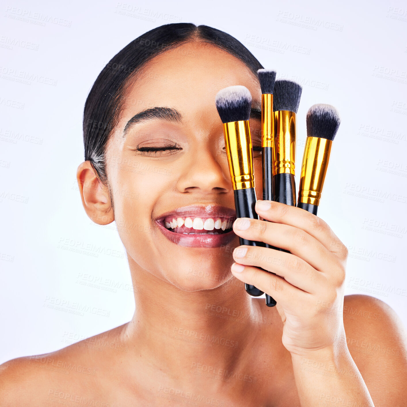 Buy stock photo Makeup brush, beauty and cosmetics of a happy woman in studio for skincare, self care and cosmetology. Skin glow, shine and wellness of a female model with facial application tools for foundation