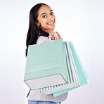 Portrait, woman and bag of shopping in studio, white background and fashion deal in retail package. Happy female customer, gift bags and luxury present from mall, discount market and sales promotion