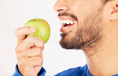 Buy stock photo Closeup, man and hands with apple for diet, natural nutrition or vitamin against a white studio background. Mouth of male person eating healthy organic fruit or bite for wellness, detox or fiber