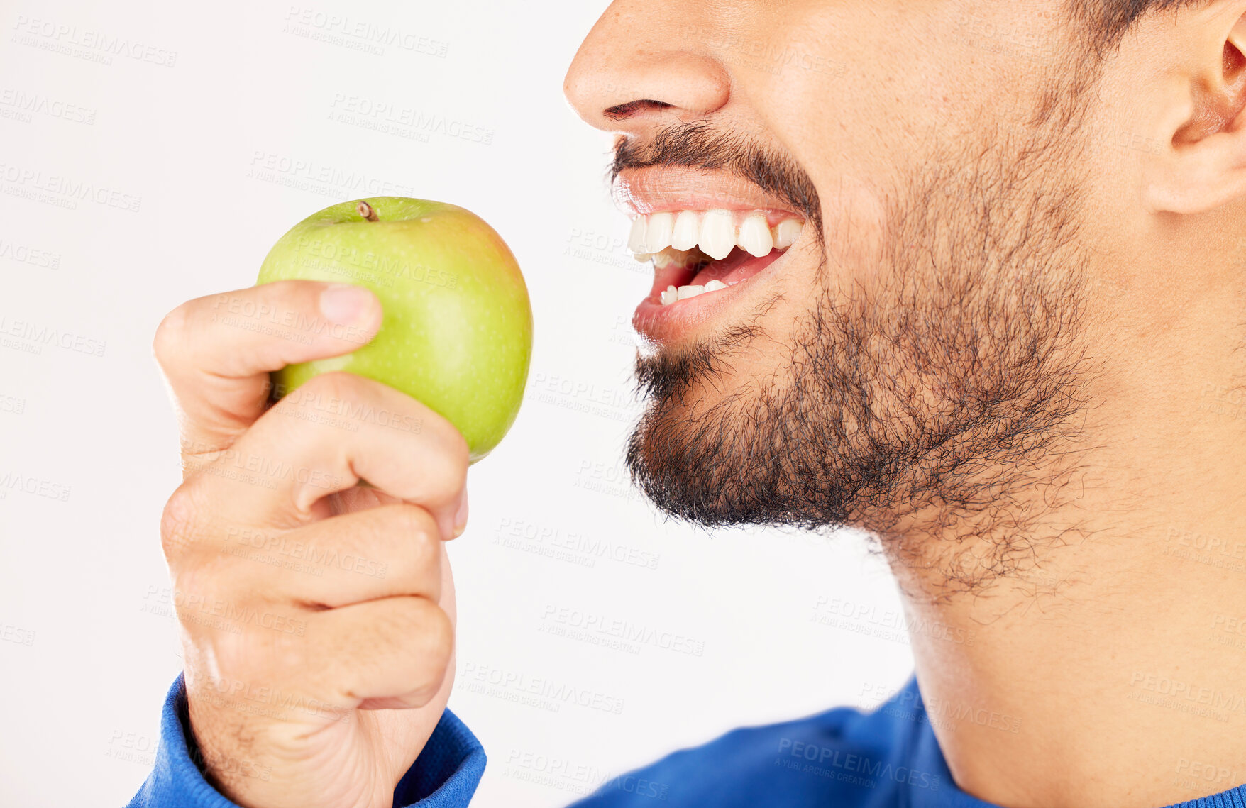 Buy stock photo Closeup, man and hands with apple for diet, natural nutrition or vitamin against a white studio background. Mouth of male person eating healthy organic fruit or bite for wellness, detox or fiber