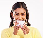 Woman, coffee and smile in studio portrait for fashion, relax or drink for health, energy and aroma by white background. Gen z girl, happy student and cup for coco, matcha or espresso with flavor